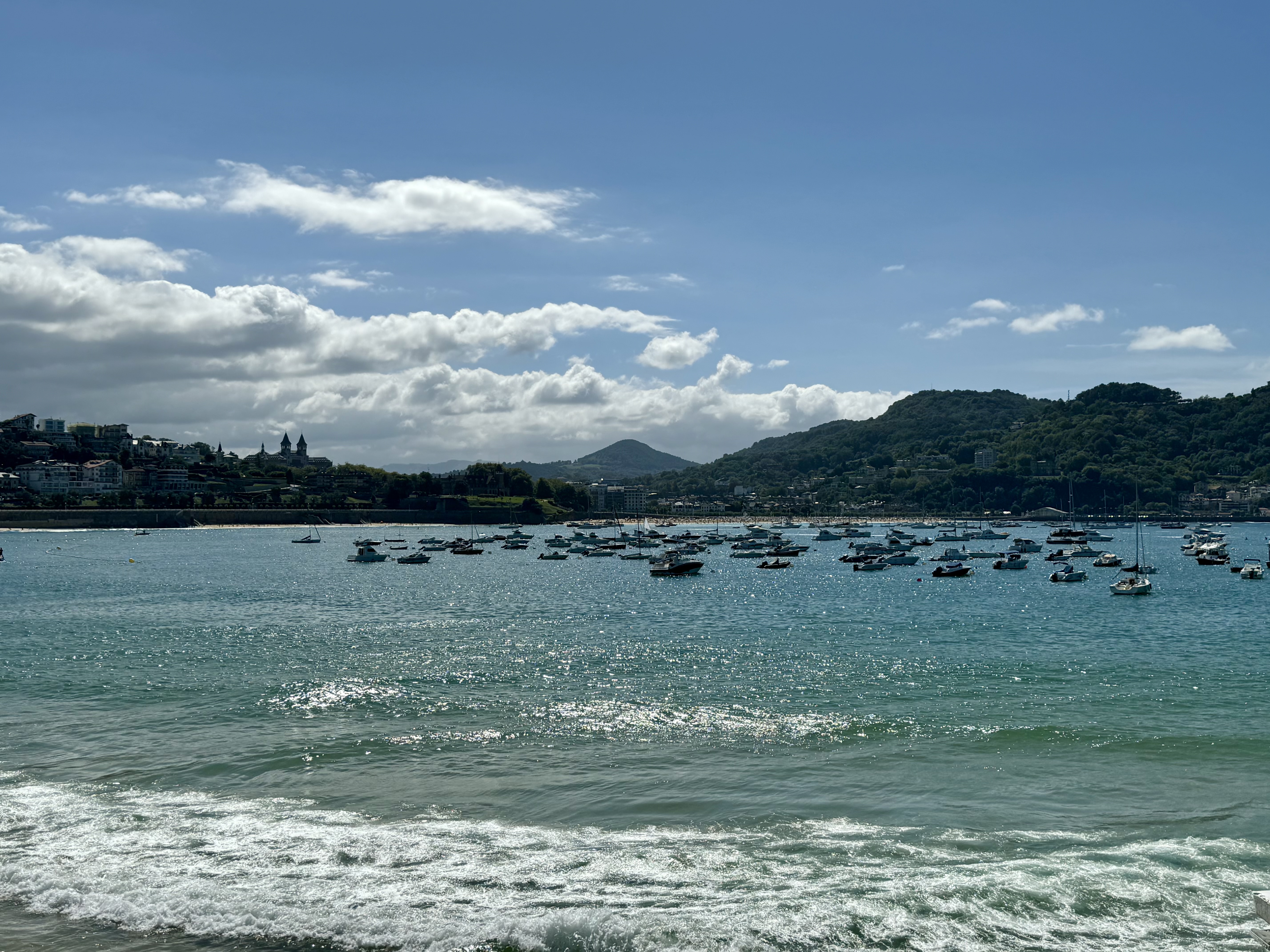 Sea with boats near coastline