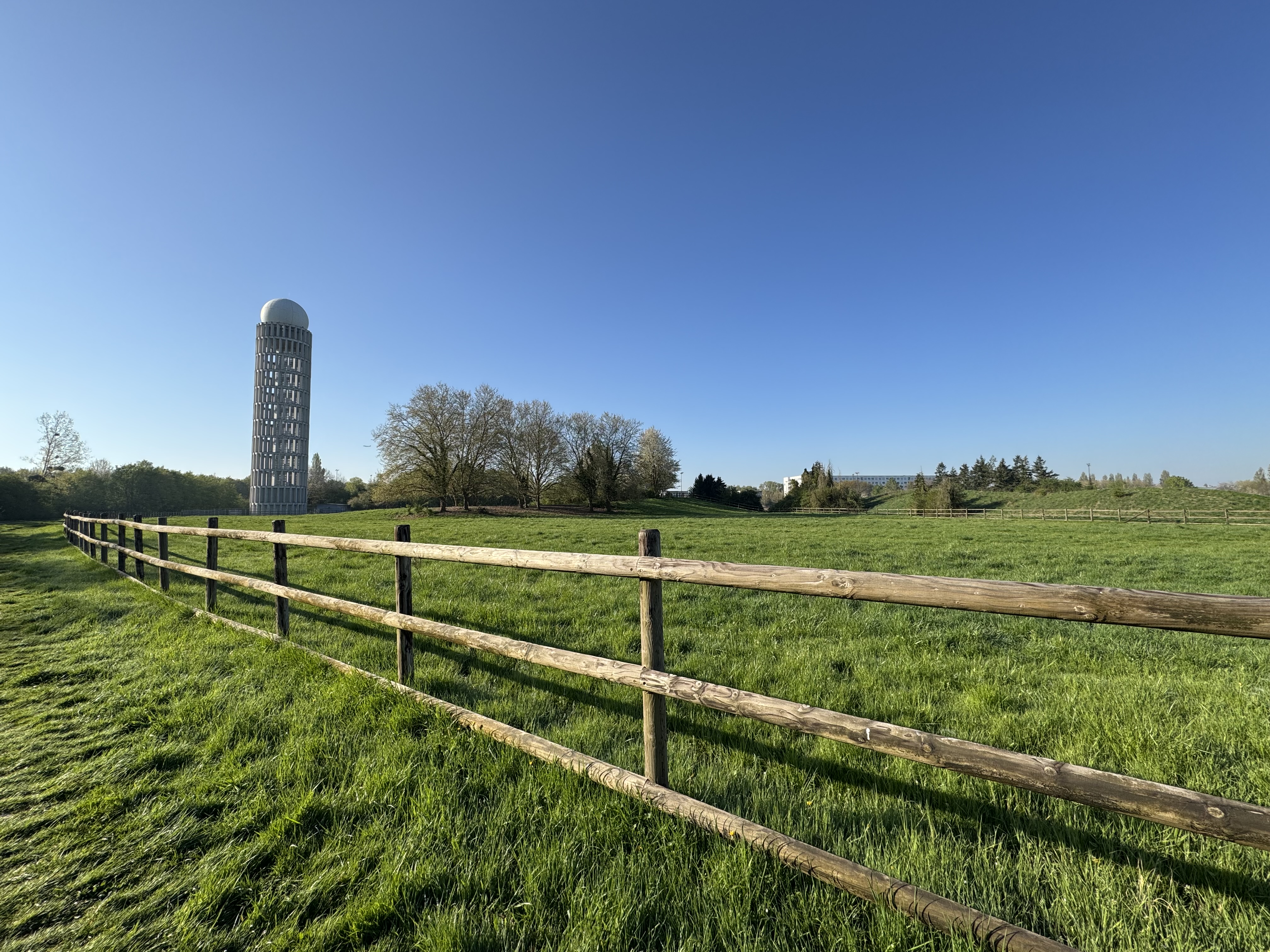Field with wooden fence and tower